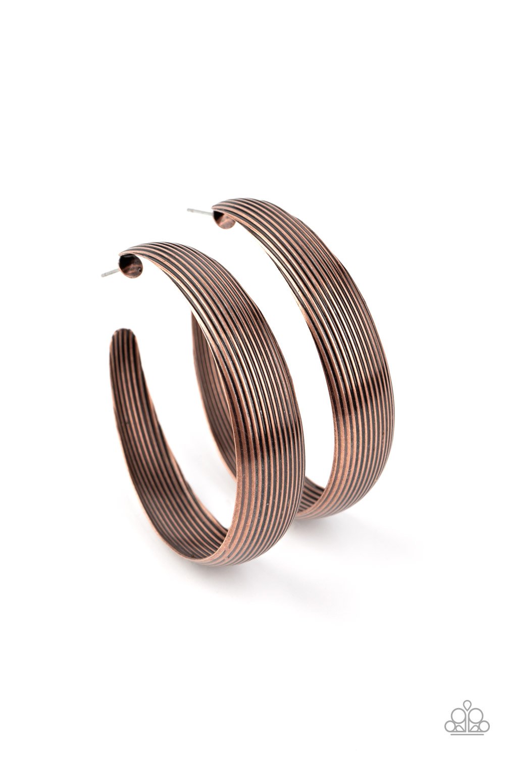 Lined in antiqued ridges, a thick copper hoop curls around the ear for an authentically rustic look. Earring attaches to a standard post fitting. Hoop measures approximately 2 ¼” in diameter. Sold as one pair of hoop earrings.