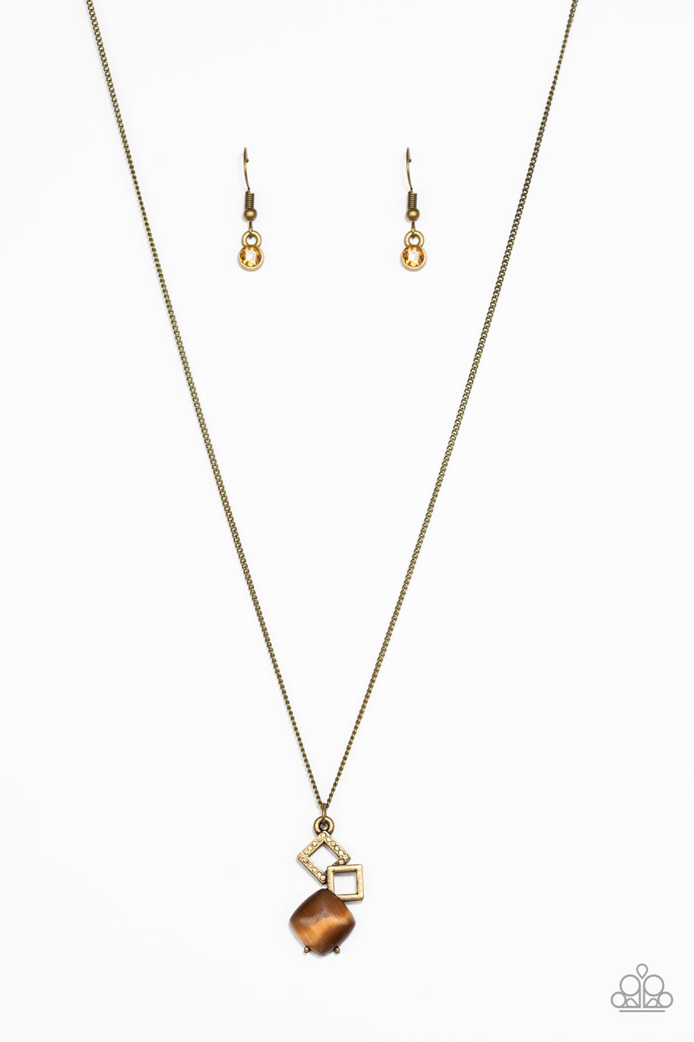A topaz rhinestone encrusted square, a shimmery brass square, and a glowing brown moonstone tumble down the chest, coalescing into a stylish pendant. Features an adjustable clasp closure. Sold as one individual necklace. Includes one pair of matching earrings.