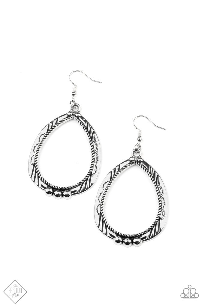 Decorated in metallic rope-like textures, a studded silver teardrop frame is stamped and etched in tribal inspired patterns for a rustic flair. Earring attaches to a standard fishhook fitting.
Sold as one pair of earrings.