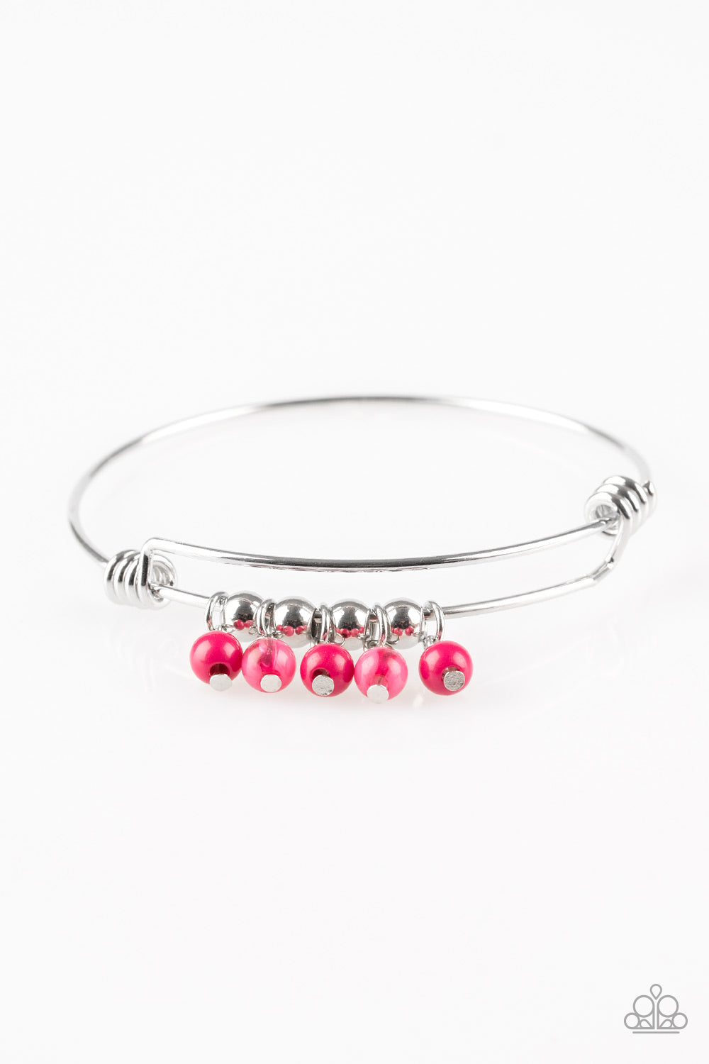 Silver wire coils around the wrist, creating an adjustable-like bangle. Glassy pink beads slide between two wire wrap fittings, creating colorful accents along the wrist. Sold as one individual bracelet.