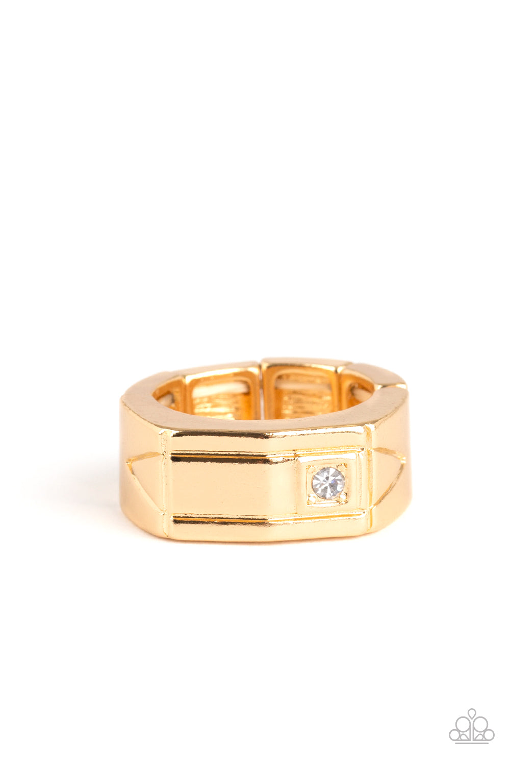 A glassy white rhinestone is pressed into the corner edge of a geometric stamped rectangular gold frame. Features a stretchy band for a flexible fit. Sold as one individual ring.