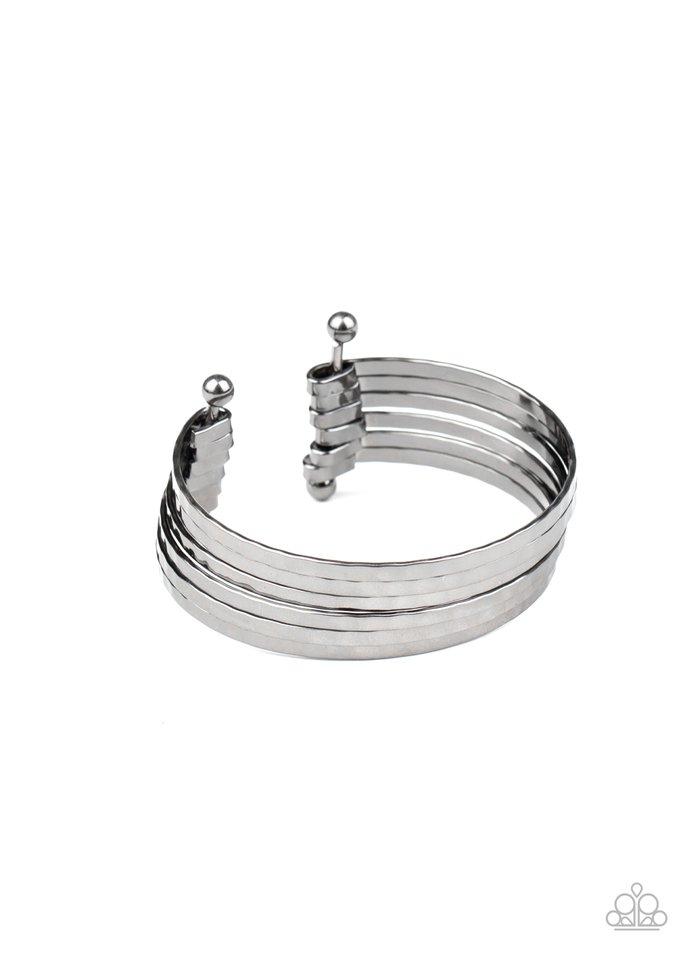 Brushed in a high-sheen shimmer, hammered gunmetal bars arc across the wrist. The flattened bars connect to two rod fittings, creating a trendy layered cuff. Sold as one individual bracelet.