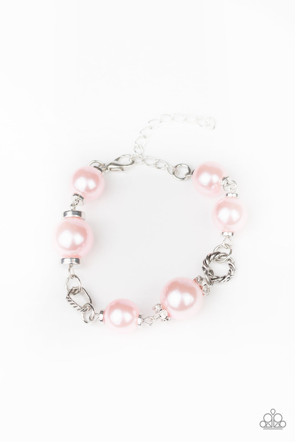 A classic collection of pink pearls, white rhinestone encrusted rings, and ornate silver accents link across the wrist for a timeless look. Features an adjustable clasp closure.
Sold as one individual bracelet.