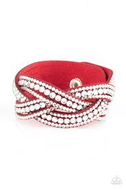 Varying in size, glassy white rhinestones are encrusted along interwoven red suede bands, creating blinding shimmer across the wrist. Features an adjustable snap closure. Sold as one individual bracelet.