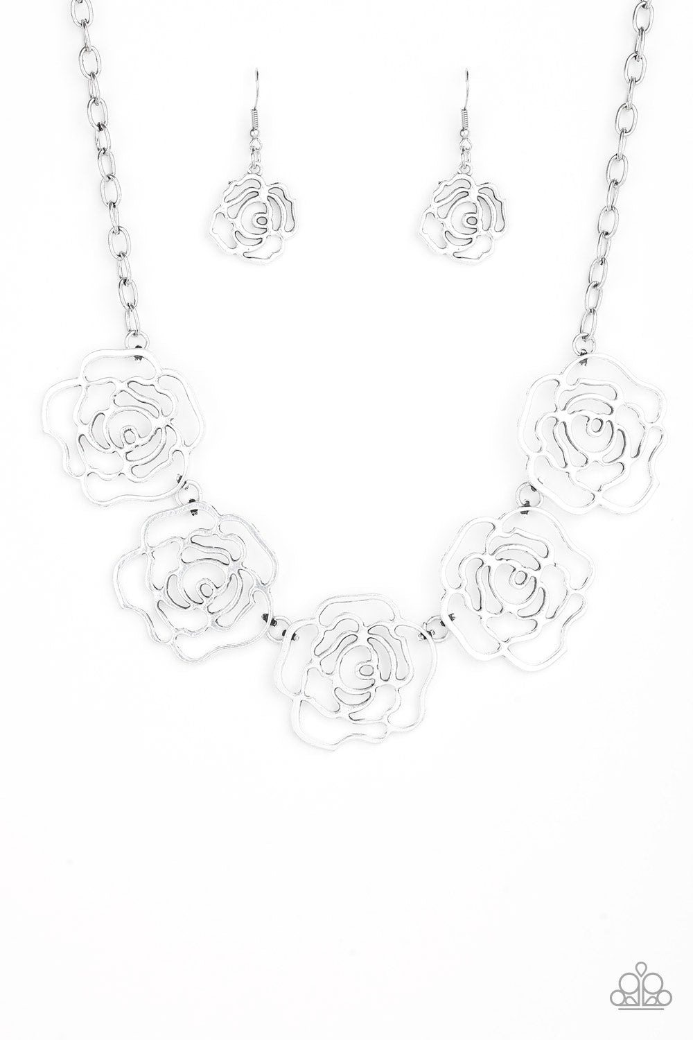 Brushed in a high-sheen finish, stenciled silver rosebuds link below the collar for a seasonal fashion. Features an adjustable clasp closure. Sold as one individual necklace. Includes one pair of matching earrings.