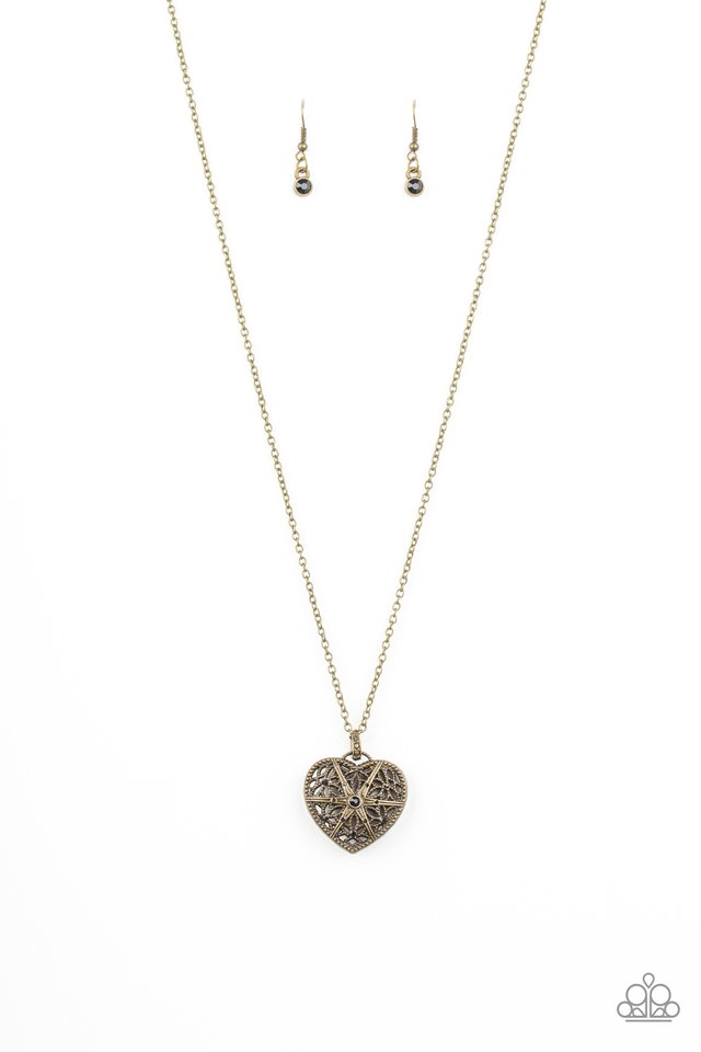 Encrusted in glittery black rhinestones, a vintage inspired heart pendant swings from the bottom of a shimmery brass chain for a romantic fashion. Features an adjustable clasp closure. Sold as one individual necklace. Includes one pair of matching earrings.