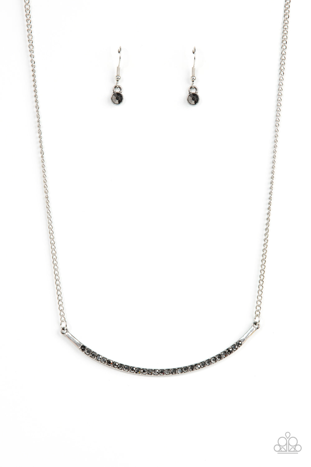 Encrusted in smoky hematite rhinestones, a curved silver bar bows below the collar for a smoldering style. Features an adjustable clasp closure. Sold as one individual necklace. Includes one pair of matching earrings.