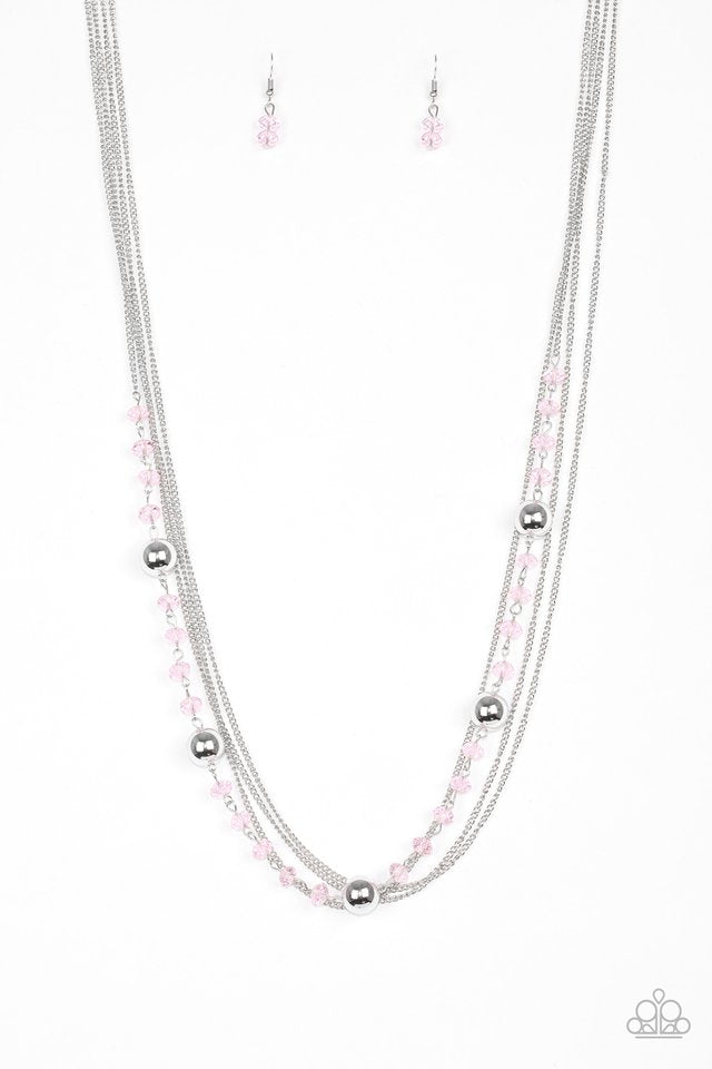 Infused with rows of shimmery silver chains, a strand of glittery pink crystal-like beads and classic silver accents drape across the chest for a regal finish. Features an adjustable clasp closure. Sold as one individual necklace. Includes one pair of matching earrings.