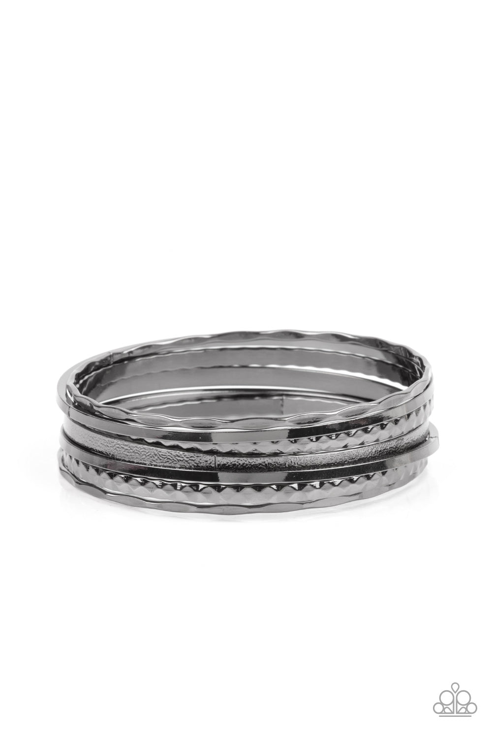 Varying in hammered, diamond-cut, and shiny finishes, a collection of mismatched gunmetal bangles stack across the wrist for an intense industrial look. Sold as one set of seven bracelets.
