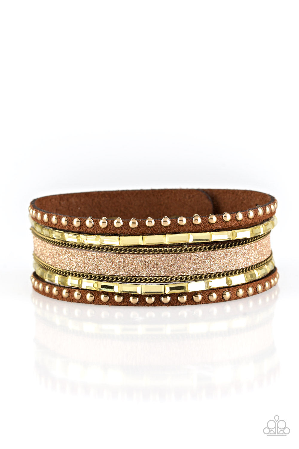 Shimmery brass studs, dainty brass chains, and golden emerald style cut rhinestones are encrusted along a brown suede band dusted in a sparkling center for a sassy look. Features an adjustable snap closure. Sold as one individual bracelet.