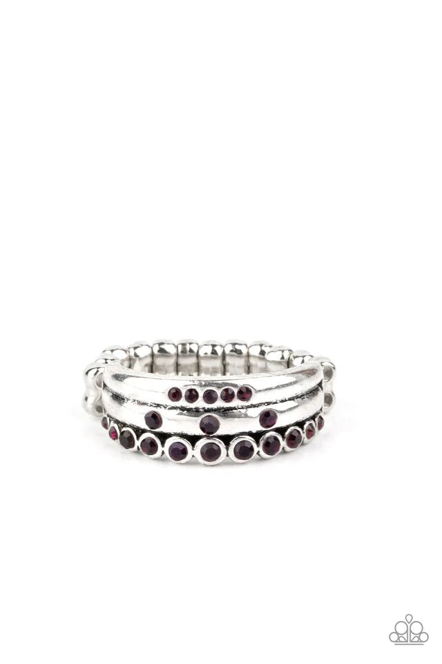 Sporadically dotted in glittery purple rhinestones, three dainty silver bands layer across the finger for an exceptionally sparkly look. Features a dainty stretchy band for a flexible fit. Sold as one individual ring.