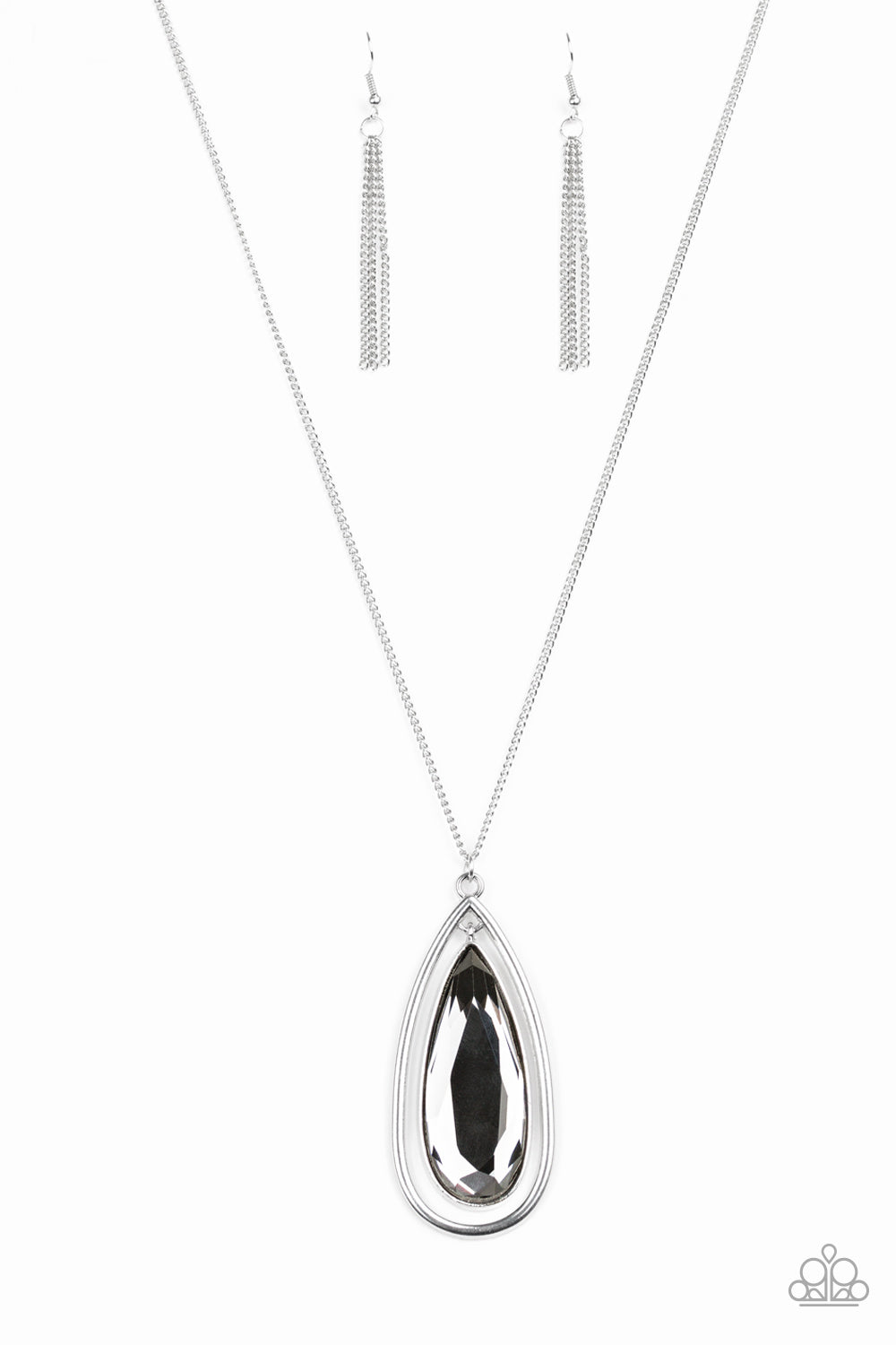 An oversized smoky teardrop gem swings from the top of a glistening silver teardrop frame. The dramatic pendant swings from the bottom of an elegantly elongated silver chain for a regal finish. Features an adjustable clasp closure. Sold as one individual necklace. Includes one pair of silver fringe earrings.