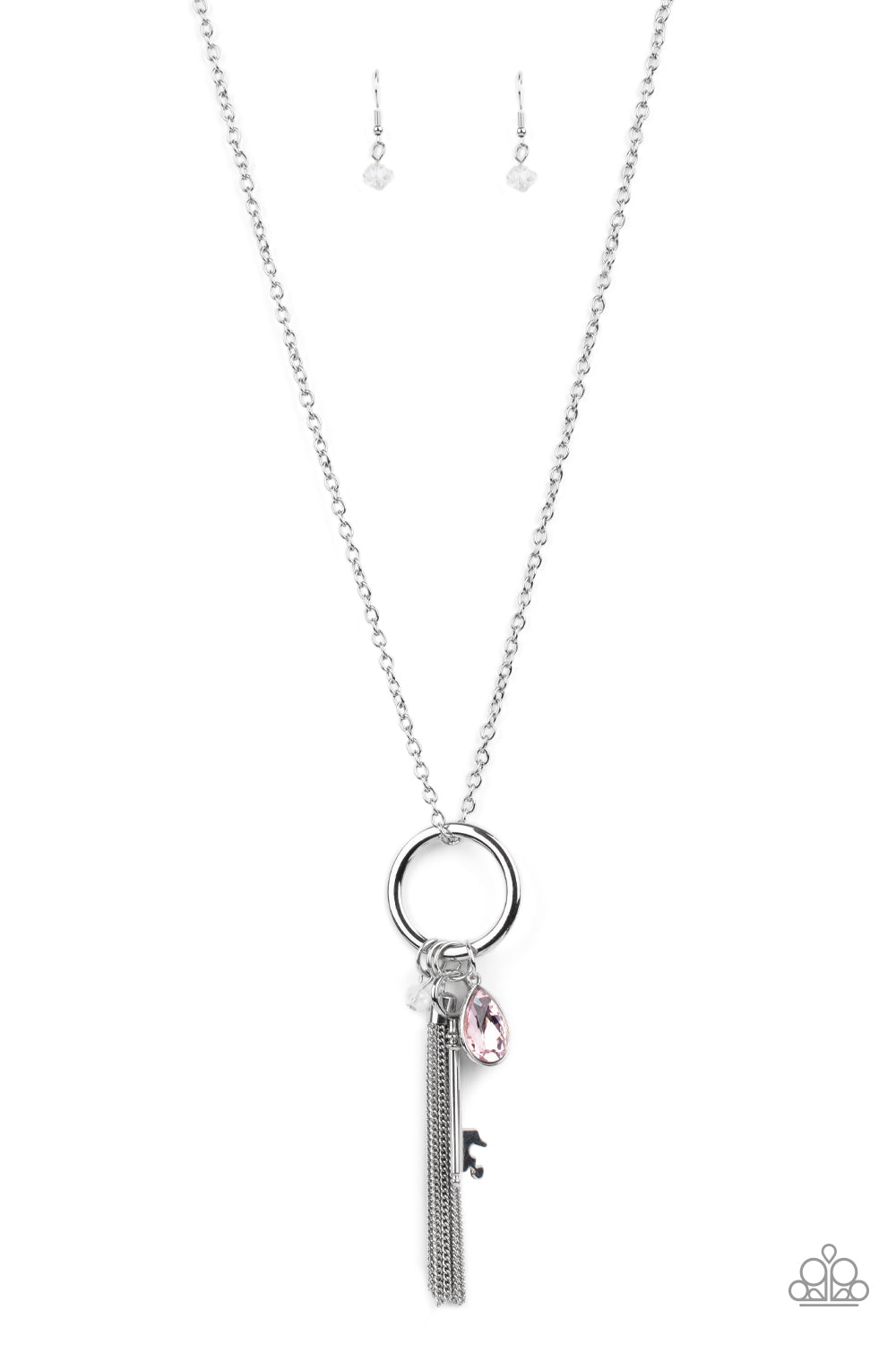 A pink teardrop gem, silver key, dainty crystal-like bead, and shimmery silver chain tassel swing from the bottom of a silver ring at the bottom of a lengthened silver chain, creating a whimsically tasseled display. Features an adjustable clasp closure. Sold as one individual necklace. Includes one pair of matching earrings.