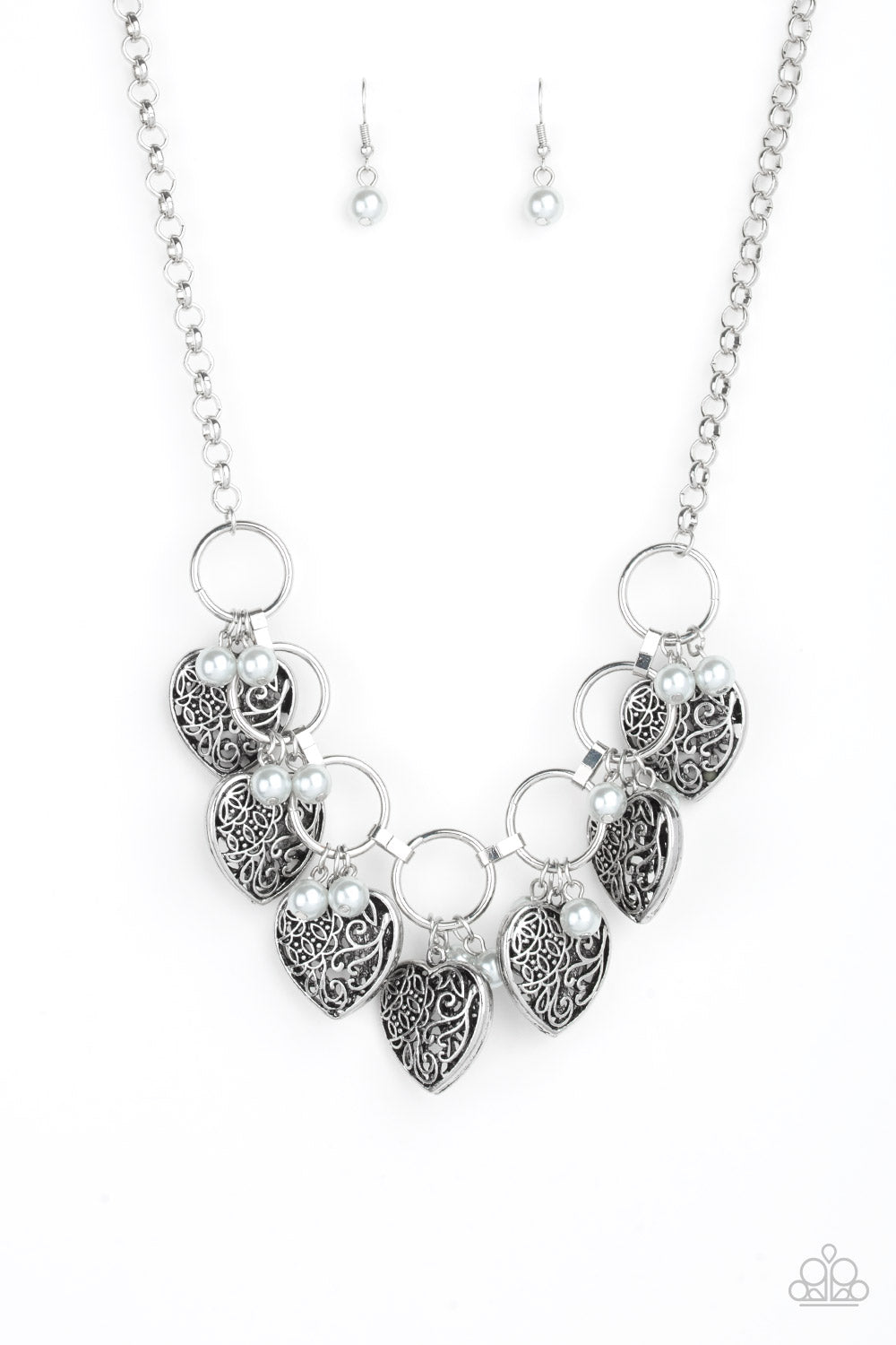 Infused with classic silver pearls, vintage locket-like heart frames swing from the bottoms of bold silver hoops, creating a flirtatious fringe below the collar. Features an adjustable clasp closure. Sold as one individual necklace. Includes one pair of matching earrings.