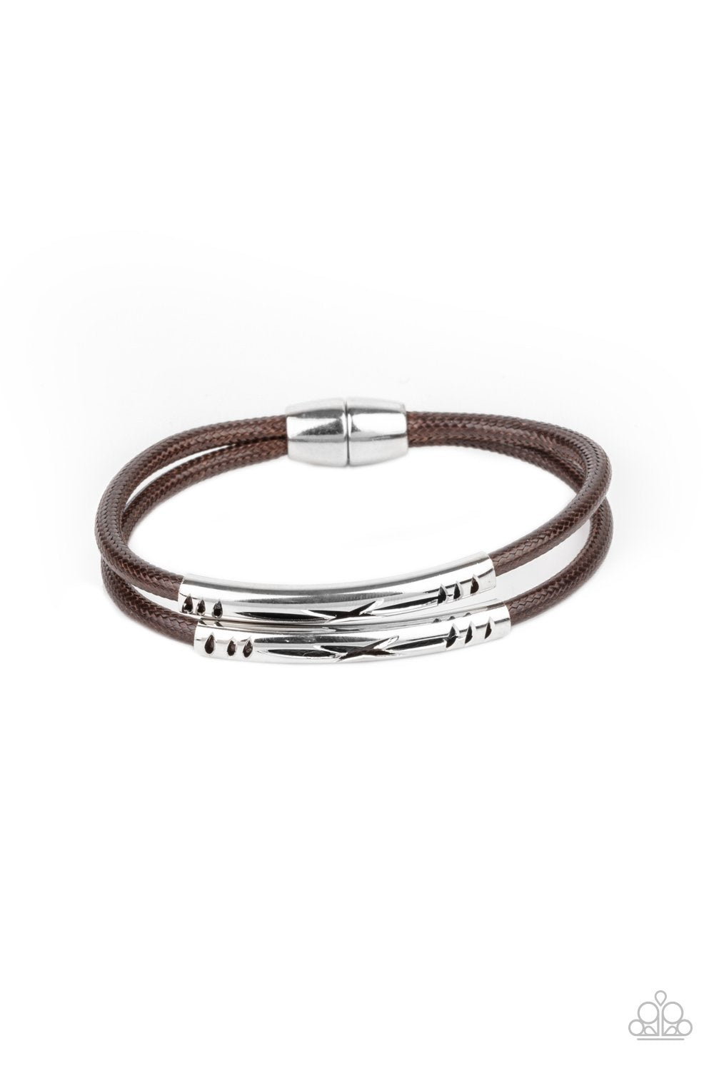 Featuring tribal inspired cutouts, stenciled silver bars slide along two shiny brown cords around the wrist for an adventurous look. Features a magnetic closure.
Sold as one individual bracelet.