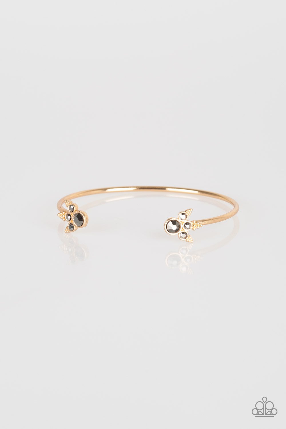 Featuring regal hematite rhinestone encrusted fittings, a dainty gold cuff curls around the wrist for a refined look. Sold as one individual bracelet.