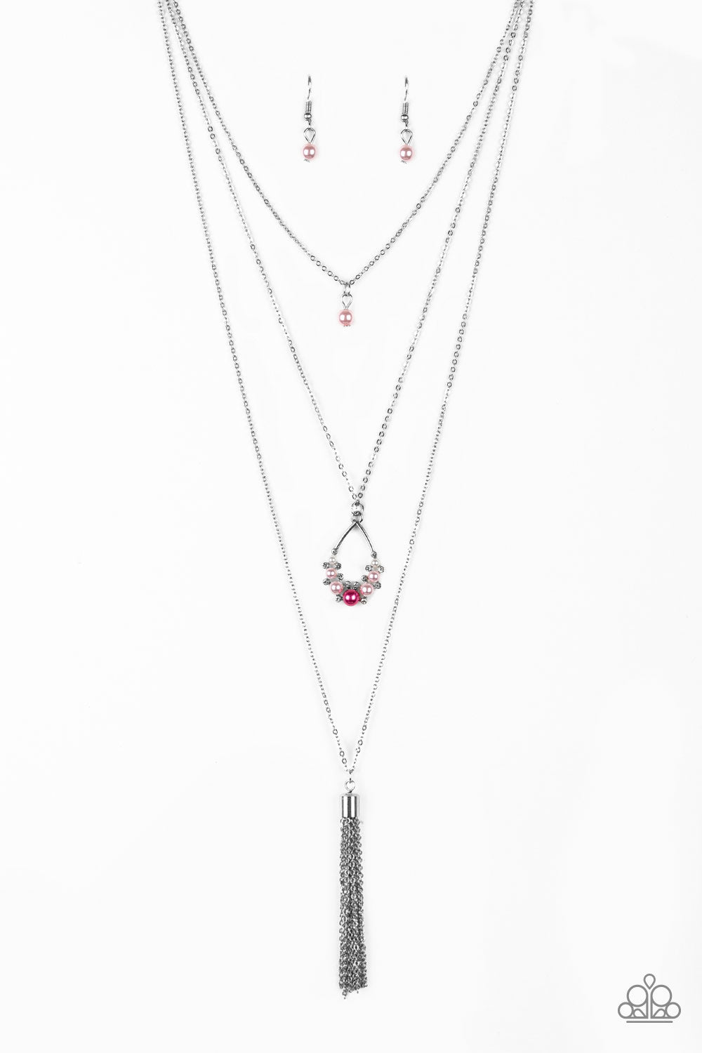 A solitaire pink pearl swings from the uppermost chain, giving way to a teardrop pendant and shimmery silver chain tassel. Dainty white rhinestones and pink pearls collect at the bottom of the centermost pendant for a glamorous finish. Features an adjustable clasp closure.
Sold as one individual necklace. Includes one pair of matching earrings.