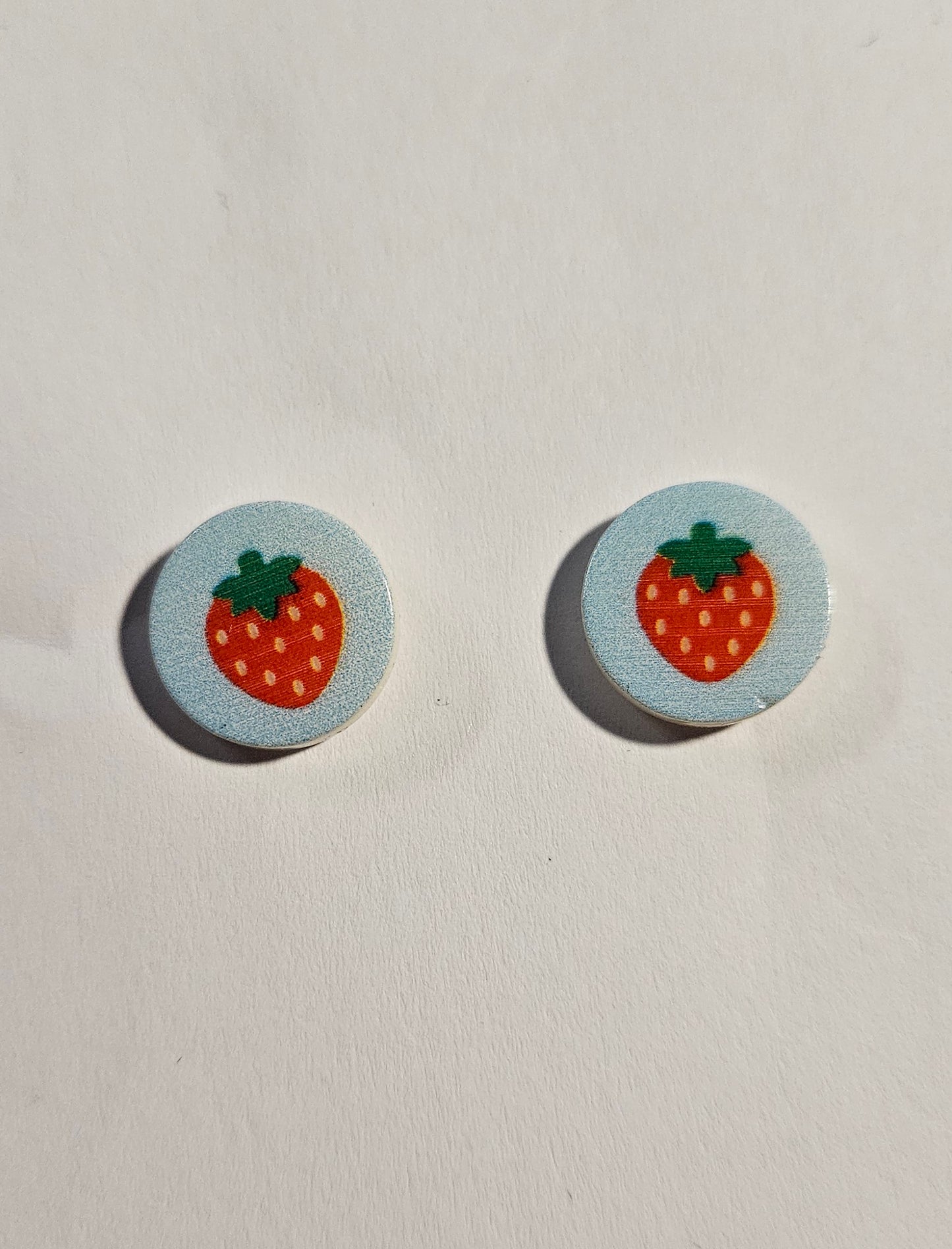 Kid's blue round earring with strawberries in center