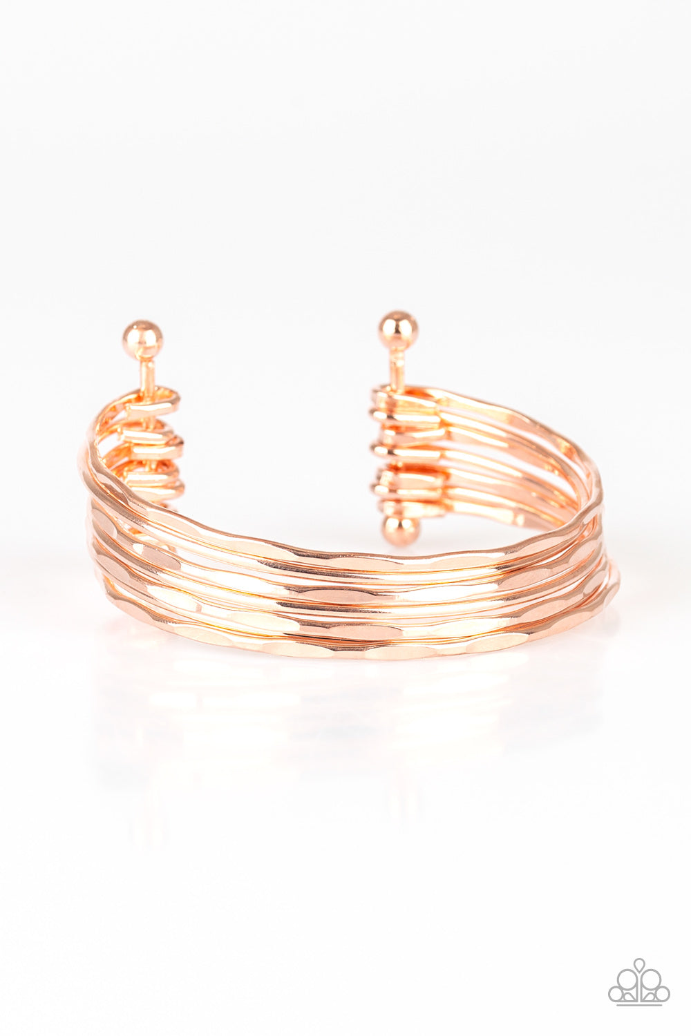 Attached to two rose gold rods, hammered rose gold bars arc across the wrist, coalescing into a classic stacked cuff. Sold as one individual bracelet.
