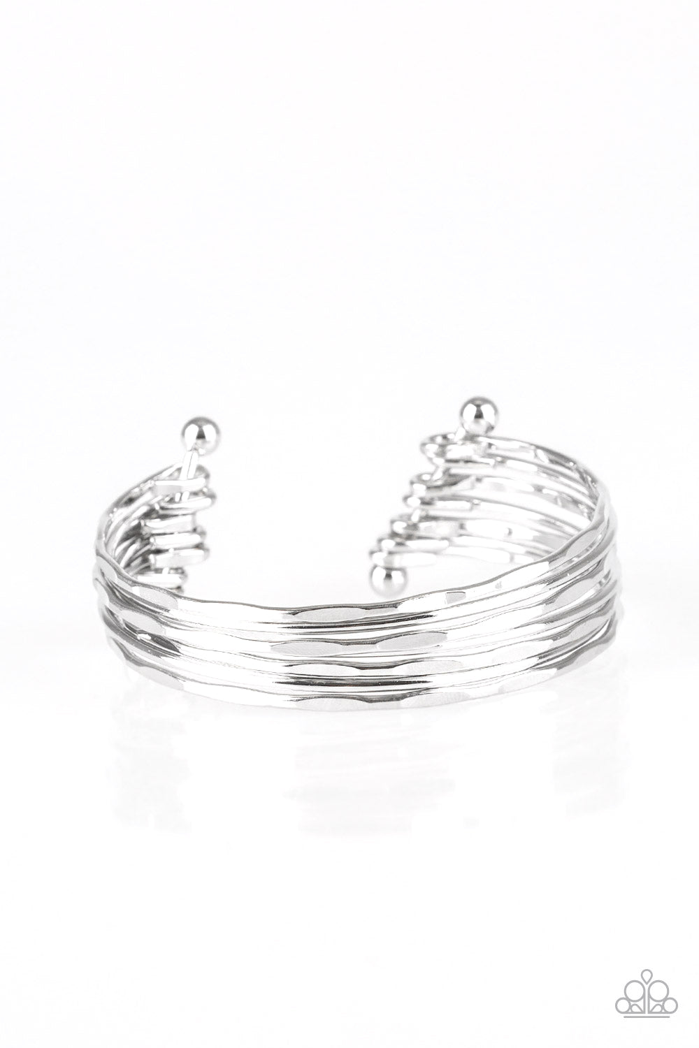 Attached to two silver rods, hammered silver bars arc across the wrist, coalescing into a classic stacked cuff. Sold as one individual bracelet.