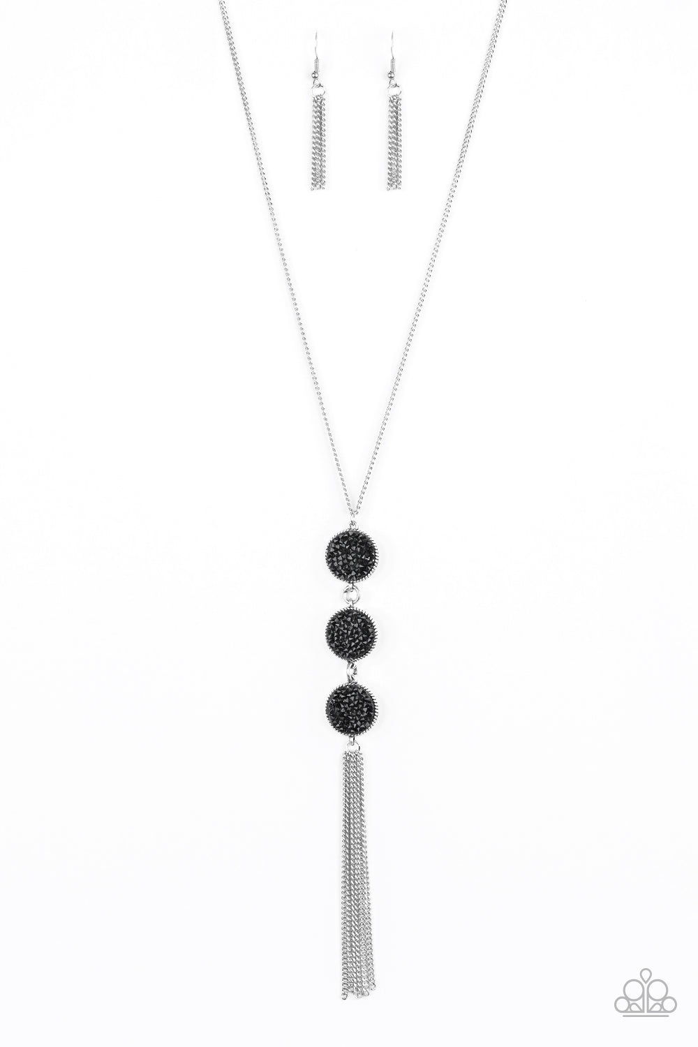 Sprinkled in glittery black prism style rhinestones, three sparkling silver frames trickle down the chest. A shimmery silver tassel swings from the bottom of the triple stacked pendant for a glamorous finish. Features an adjustable clasp closure. Sold as one individual necklace. Includes one pair of matching earrings.