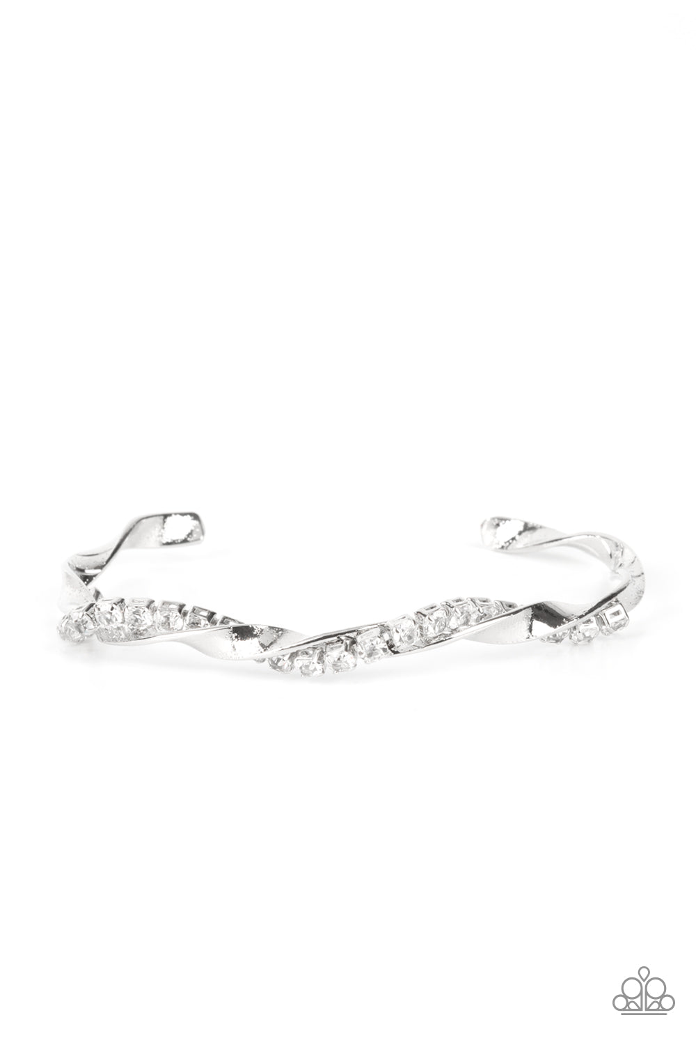 A glittery strand of glassy white rhinestones twists with a shiny silver bar around the wrist, creating a dainty cuff. Sold as one individual bracelet.