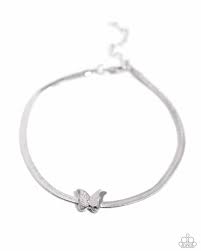 Featuring a lightly hammered texture, a dainty silver butterfly joins a sleek silver butterfly for a three-dimensional pendant that flutters atop a silver herringbone chain around the ankle for a whimsical finish. Features an adjustable clasp closure. Sold as one individual anklet.