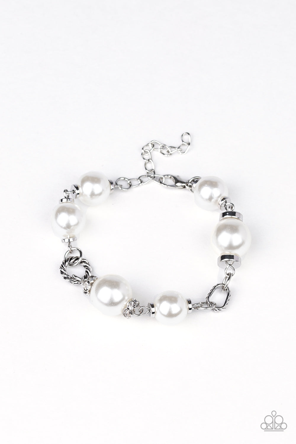 A classic collection of white pearls, white rhinestone encrusted rings, and ornate silver accents link across the wrist for a timeless look. Features an adjustable clasp closure.
Sold as one individual bracelet.