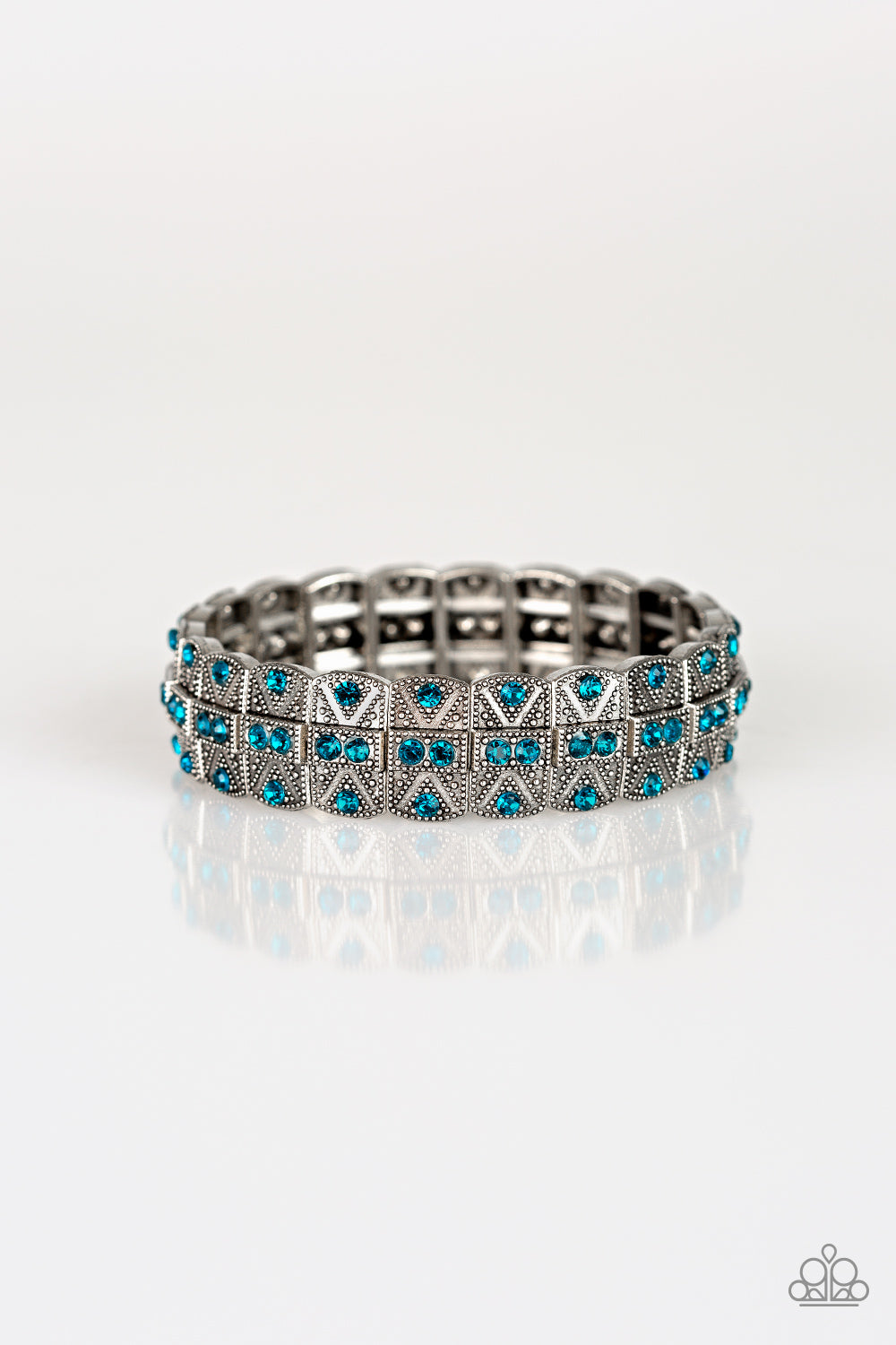 Encrusted in glittery blue rhinestones, ornately studded silver frames are threaded along stretchy bands for an edgy-glamorous look. Sold as one individual bracelet.