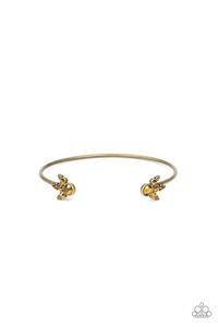 Featuring regal aurum rhinestone encrusted fittings, a dainty brass cuff curls around the wrist for a refined look. Sold as one individual bracelet.