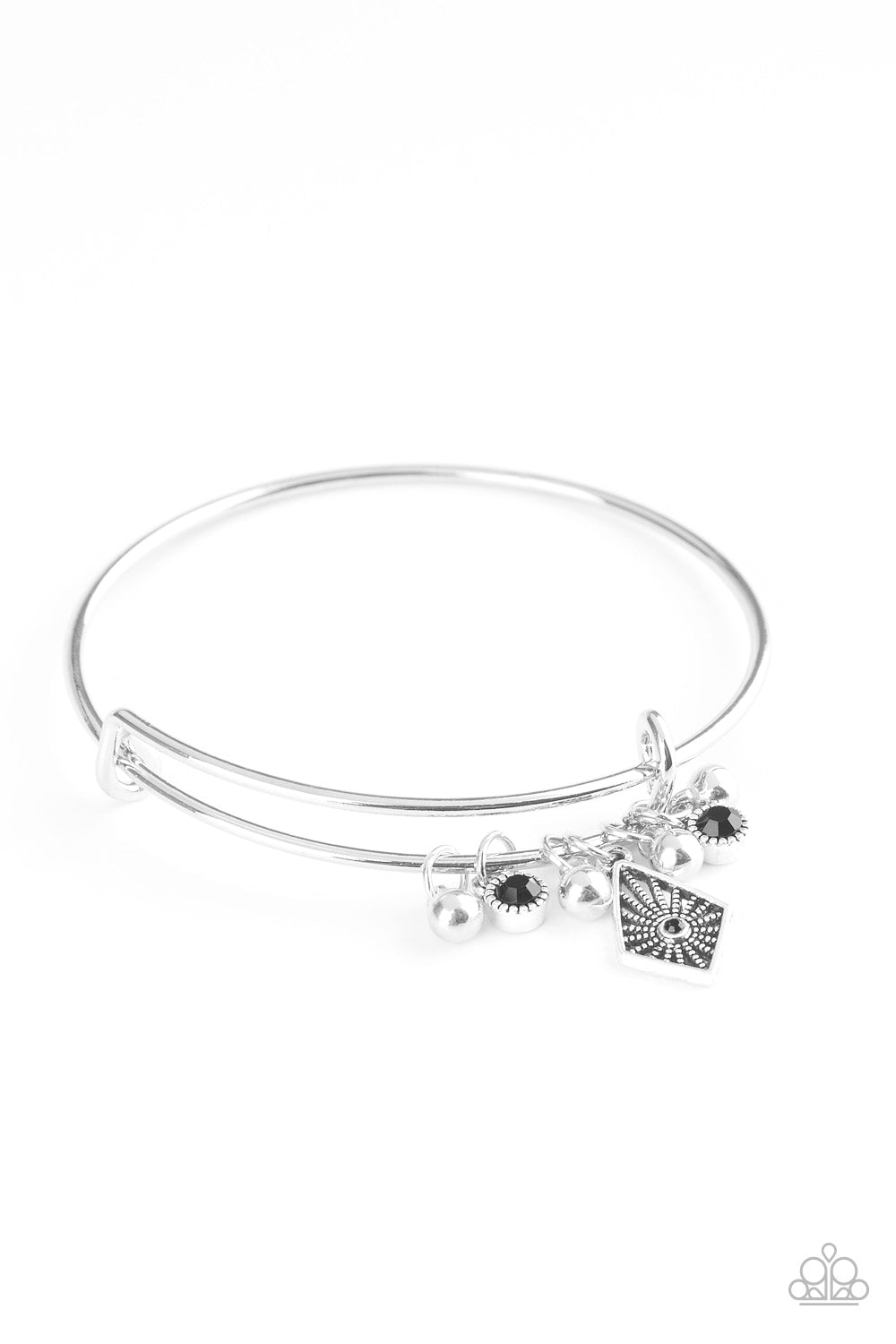 A collection of shimmery silver beads and glittery black rhinestone accents slide along a sleek bar fitting, creating whimsical charms as they glide along the dainty silver bangle. Sold as one individual bracelet.