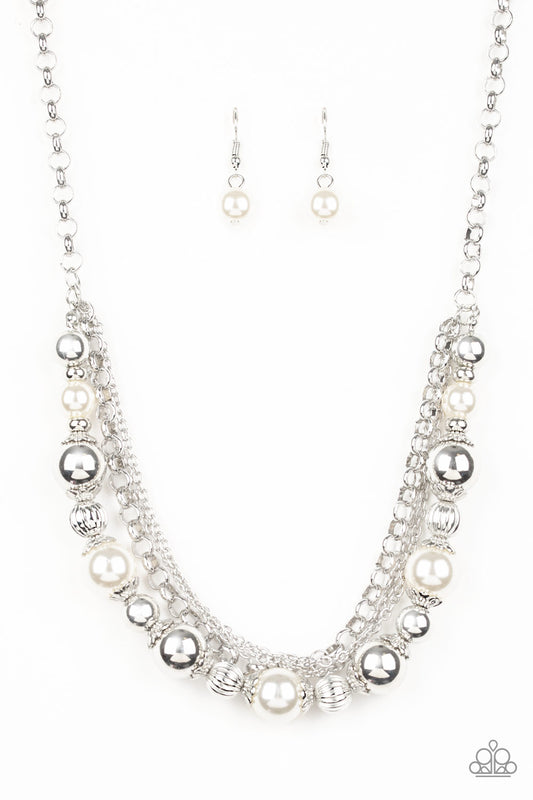Layers of mismatched silver chains give way to a strand of ornate silver beads and oversized white pearls that cascade below the collar for a refined flair. Features an adjustable clasp closure.  Sold as one individual necklace. Includes one pair of matching earrings.