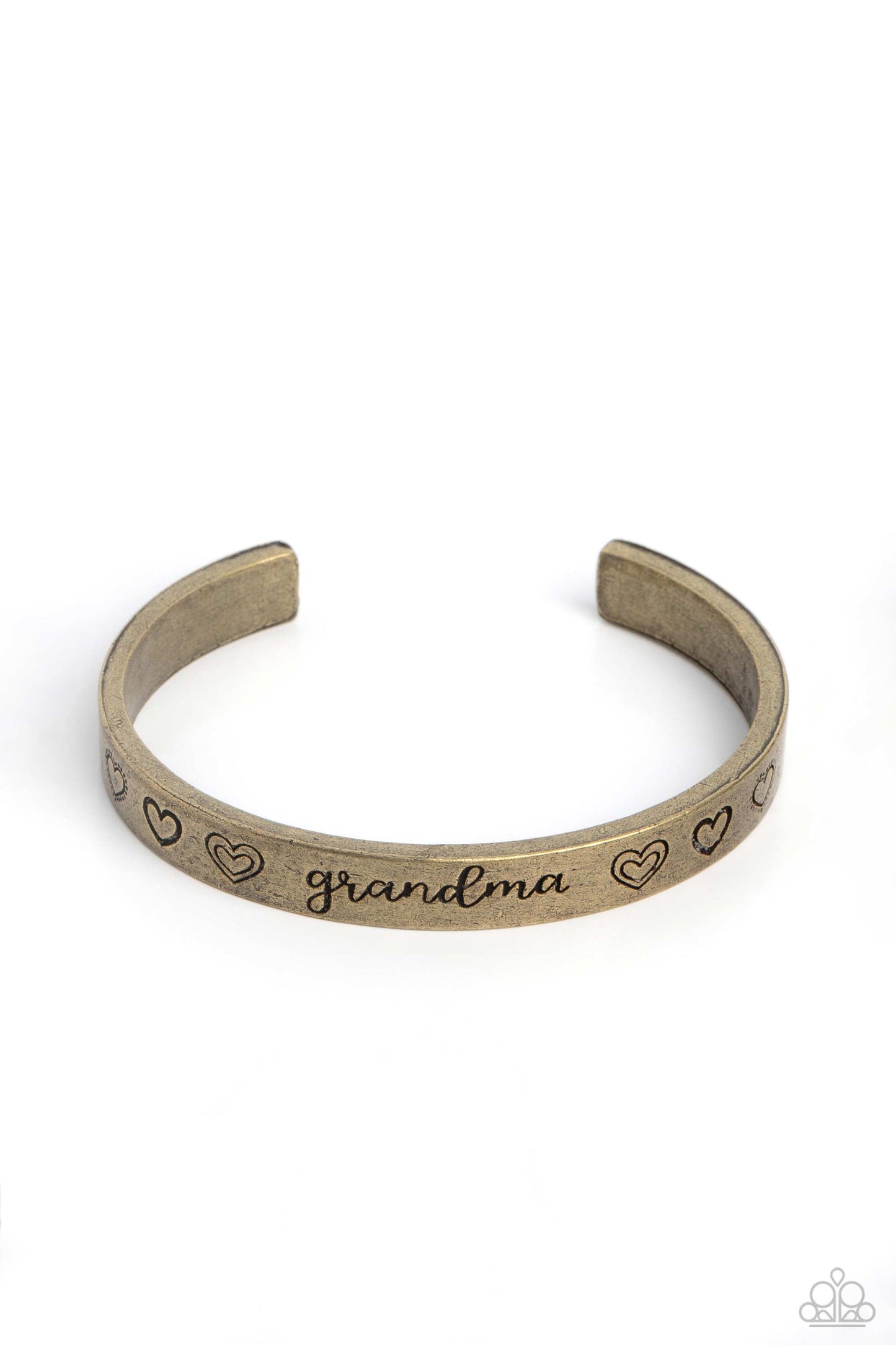 Brushed in an antiqued grit, a skinny brass bar curls around the wrist, creating a rustic cuff. Featuring a heart motif, the skinny cuff is engraved with the word “grandma” with various styles of hearts framing the word for an inspiring, heartfelt finish. Sold as one individual bracelet.