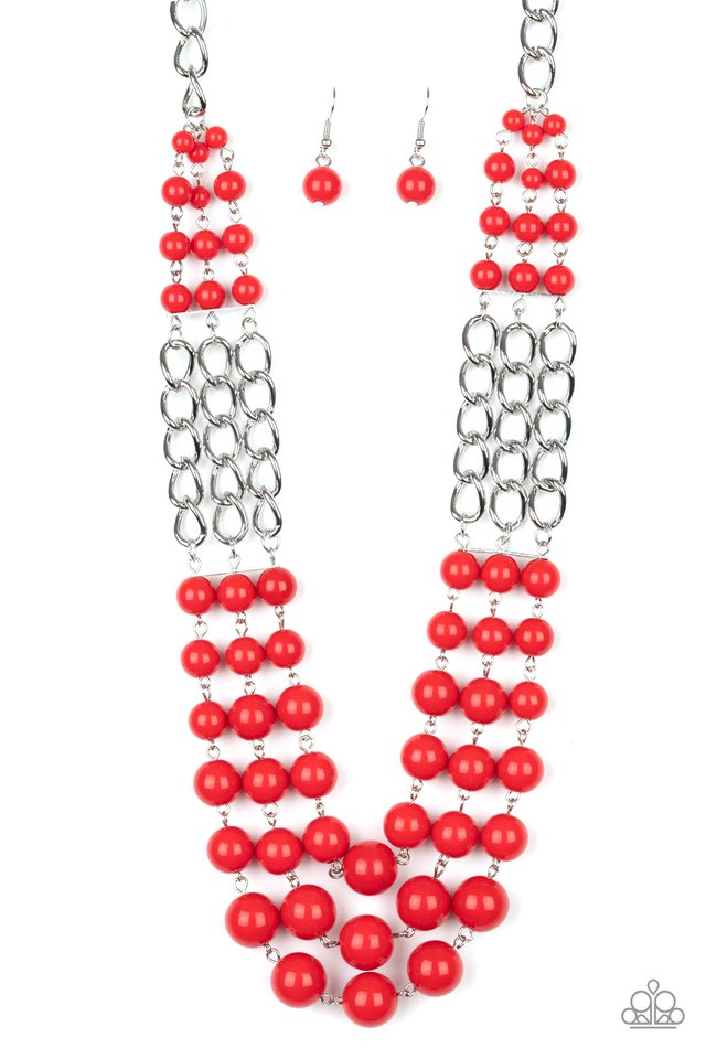 Sections of thick silver chains and bubbly red beaded rows layer below the collar, creating statement-making layers. Features an adjustable clasp closure. Sold as one individual necklace. Includes one pair of matching earrings.