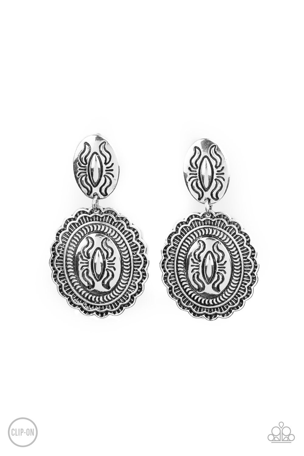 Stamped in decorative linear patterns, a ruffled silver frame dangles from the bottom of a matching oval frame, creating a one-of-a-kind lure. Earring attaches to a standard clip-on fitting. Sold as one pair of clip-on earrings.