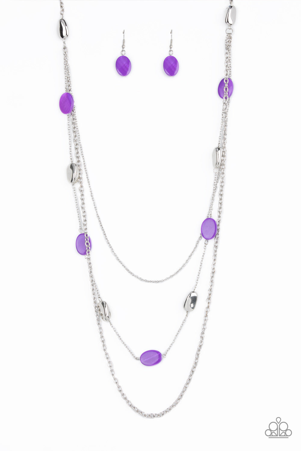 A strand of silver pebble beads and purple shell-like discs layer with two mismatched silver chain across the chest, adding a seasonal pop of color to any outfit. Features an adjustable clasp closure. Sold as one individual necklace. Includes one pair of matching earrings.