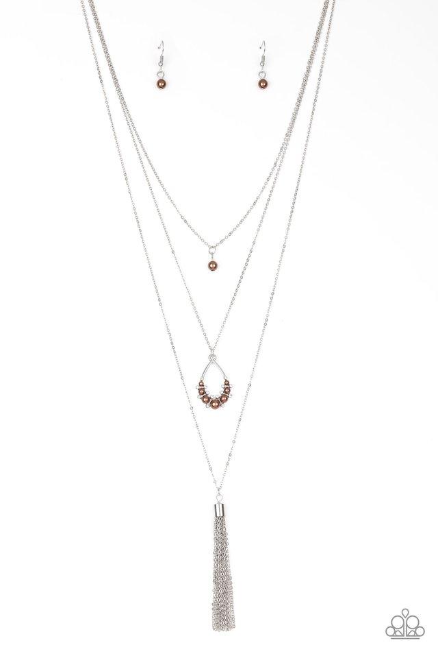 A solitaire brown pearl swings from the uppermost chain, giving way to a teardrop pendant and shimmery silver chain tassel. Dainty white rhinestones and brown pearls collect at the bottom of the centermost pendant for a glamorous finish. Features an adjustable clasp closure.
Sold as one individual necklace. Includes one pair of matching earrings.