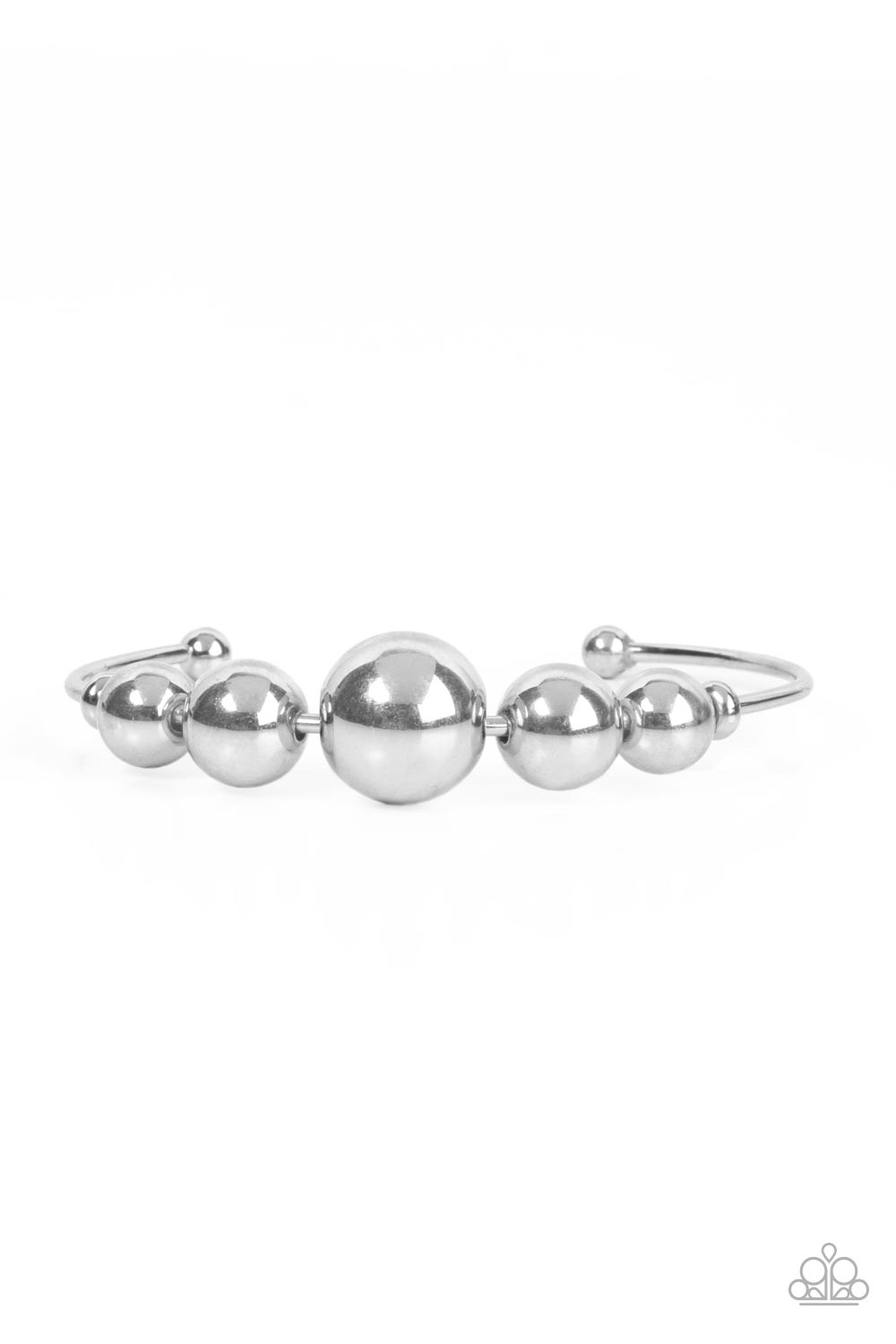 Gradually increasing in size, an oversized collection of shiny silver beads are threaded along a dainty silver cuff for a dramatic industrial display. Sold as one individual silver bracelet.