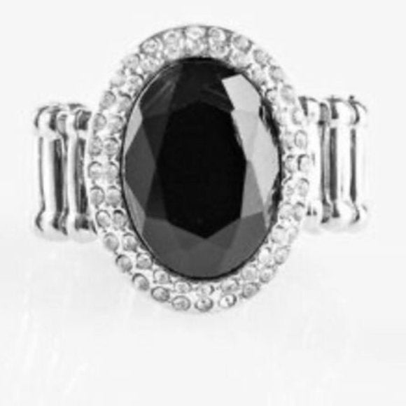 A dazzling black rhinestone gem is nestled in the center of a ring of glassy white rhinestones, creating a glamorous centerpiece atop the finger. Features a dainty stretchy band for a flexible fit. Sold as one individual ring.