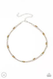 Infused with a pair of dainty silver chains, a single chain is adorned in sections of Olive Branch and Adobe seed beads as it layers around the neck for an earthy flair. Features an adjustable clasp closure. Sold as one individual choker necklace. Includes one pair of matching earrings.