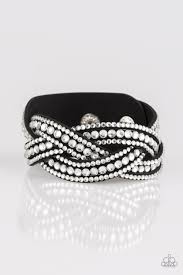Varying in size, glassy white rhinestones are encrusted along interwoven black suede bands, creating blinding shimmer across the wrist. Features an adjustable snap closure. Sold as one individual bracelet.