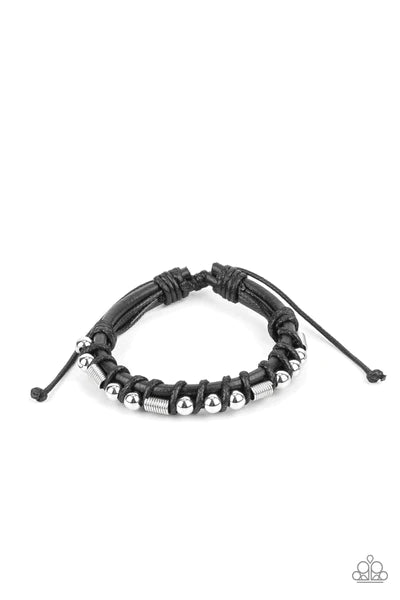 Wrapped into place with glossy black thread, shiny silver beads and cylindrical coils are threaded along a double layer of thick black leather cording creating a rustic fashion around the wrist. Features an adjustable sliding knot closure. Sold as one individual bracelet.