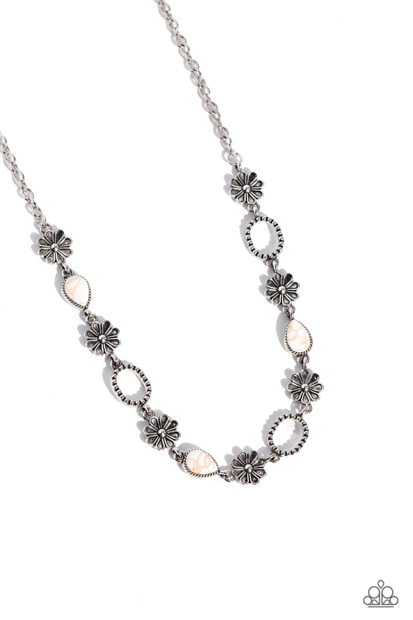 Metallic daisy charms, silver hoops studded with a dot motif, and white teardrop stones, pressed into textured silver frames interlock together around the neck for a free-spirited flair. Features an adjustable clasp closure. As the stone elements in this piece are natural, some color variation is normal. Sold as one individual necklace. Includes one pair of matching earrings.
