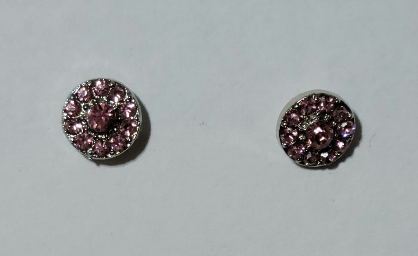 Kids' silver circle earrings with a pink rhinestones in center and smaller pink rhinestones surrounding