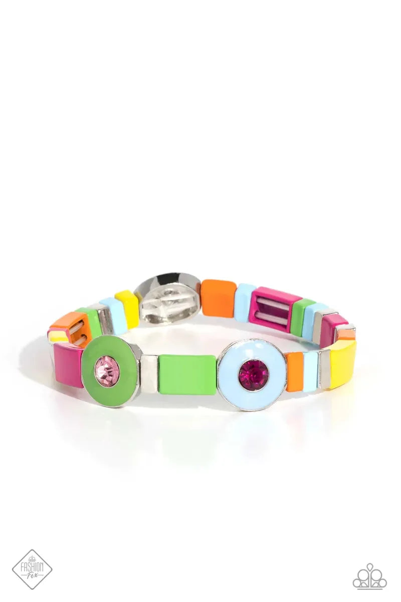 Alternating along the wrist in a whimsically colorful pattern, a collection of stacked silver cube beads, and multicolored metallic squares are threaded along an elastic stretchy band. Three circular frames, in Pantone® shades of Classic Green, Summer Song, and Fuchsia Fedora, haphazardly interrupt the cubed beading, showcasing their colorful rhinestone centers for additional contrast around the wrist. Sold as one individual bracelet.