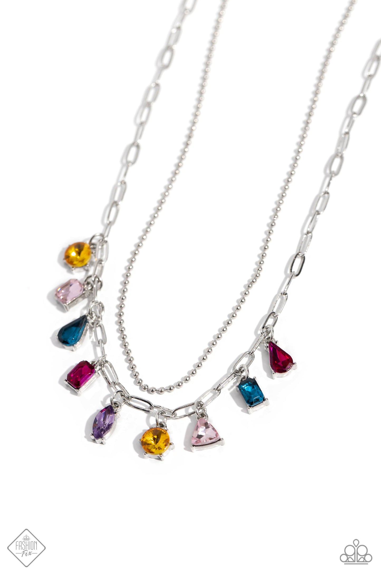 A strand of skinny silver ball chain is layered with a dainty silver paperclip chain, creating a delicate collision of refinement and grit as they lay along the collar. Set in pronged silver fittings, a multicolored gem collection in round, emerald-cut, teardrop, triangle, and marquise cuts dances from the paperclip chain for a flashy, faceted finish. Features an adjustable clasp closure. Sold as one individual necklace. Includes one pair of matching earrings.