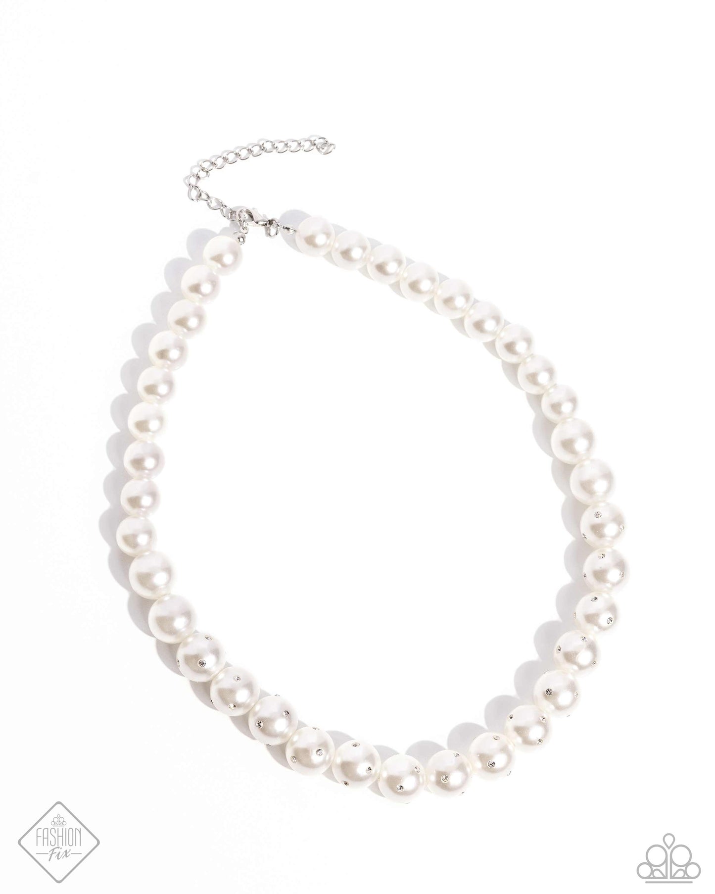 Infused along an invisible string, a collection of glossy white pearls, gradually dusted in dainty white rhinestones as it cascades towards the center of the neckline creates a radiantly, refined display. Features an adjustable clasp closure. Sold as one individual necklace. Includes one pair of matching earrings.