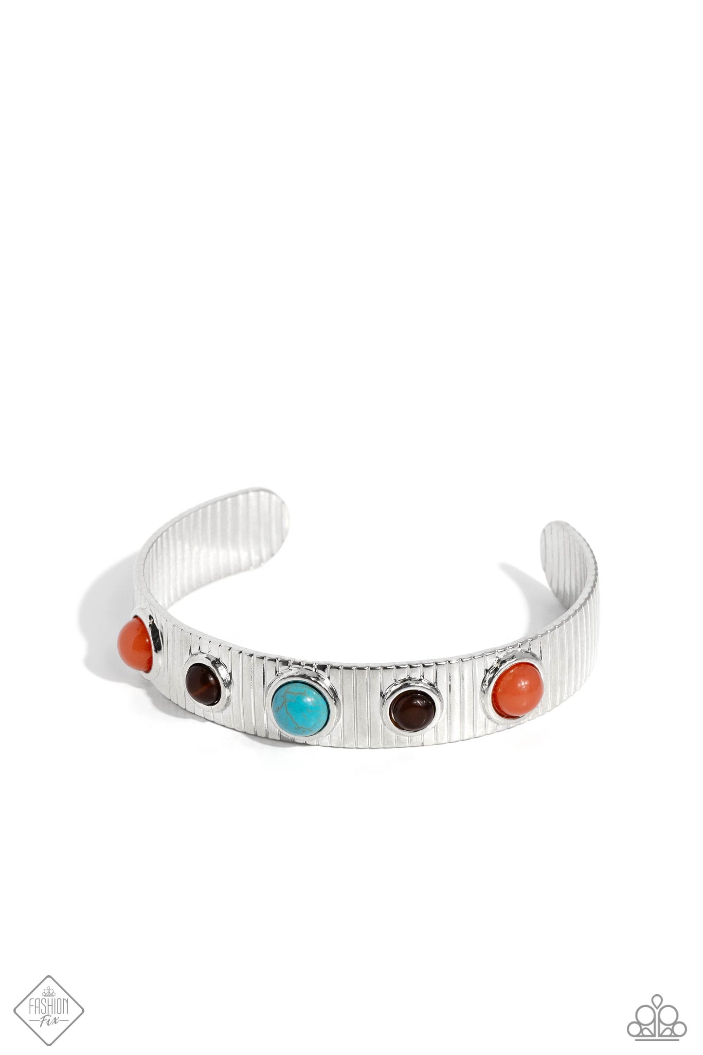 Pressed in round, elevated silver frames, a collection of Burnt Sienna, brown cat's eye, and turquoise stone beads dot along the front of a linear-textured silver cuff for a desert-patterned display. As the stone elements in this piece are natural, some color variation is normal. Sold as one individual bracelet.