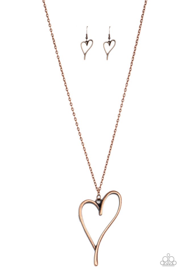 An asymmetrical copper heart charm swings from the bottom of a lengthened copper chain, creating a whimsical pendant. Features an adjustable clasp closure. Sold as one individual necklace. Includes one pair of matching earrings.