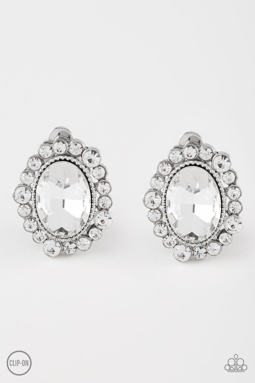 Varying in size, dainty white rhinestones spin around a faceted white gem for a timeless look. Earring attaches to a standard post fitting. Sold as one pair of post earrings.